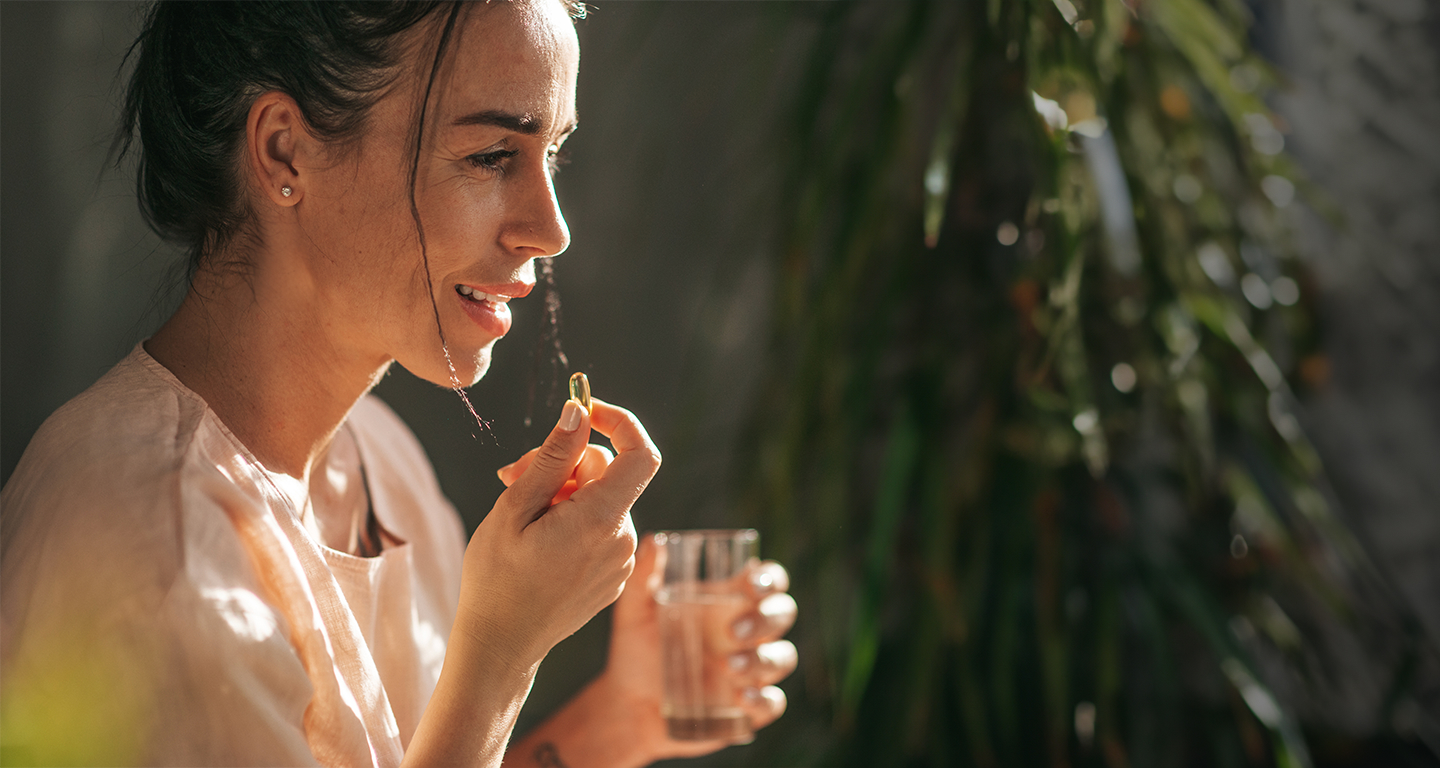 Close up girl taking a jelly capsule vitamin