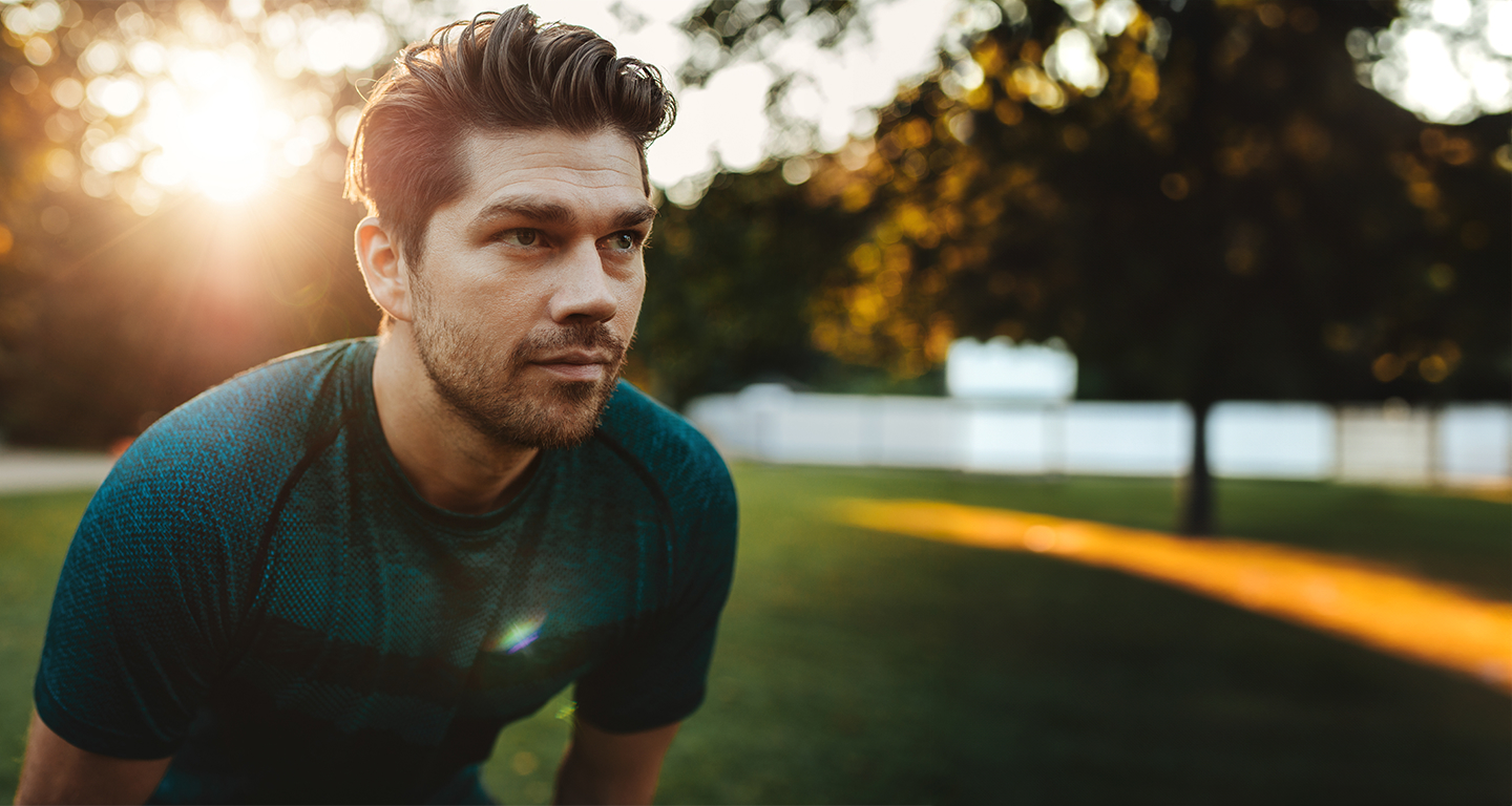 Healthy young man standing outdoors in park