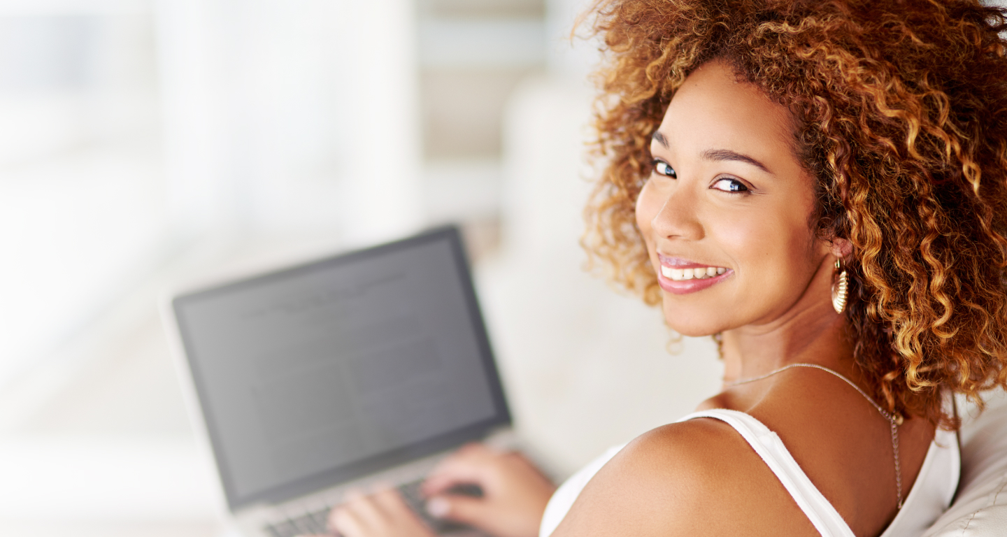 Portrait of a young woman using a laptop